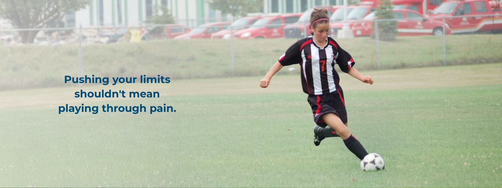 Youth athlete playing soccer, highlighting injury prevention and performance.