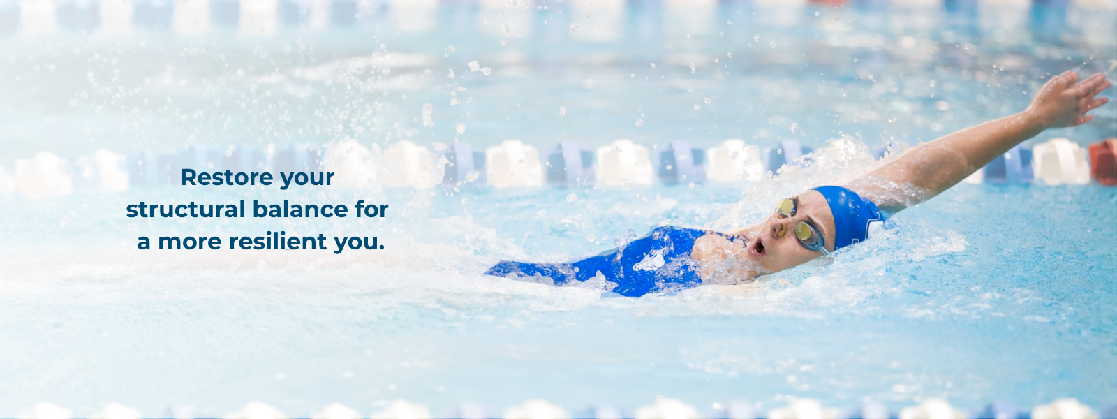 Swimmer in pool demonstrating structural balance and physical resilience.
